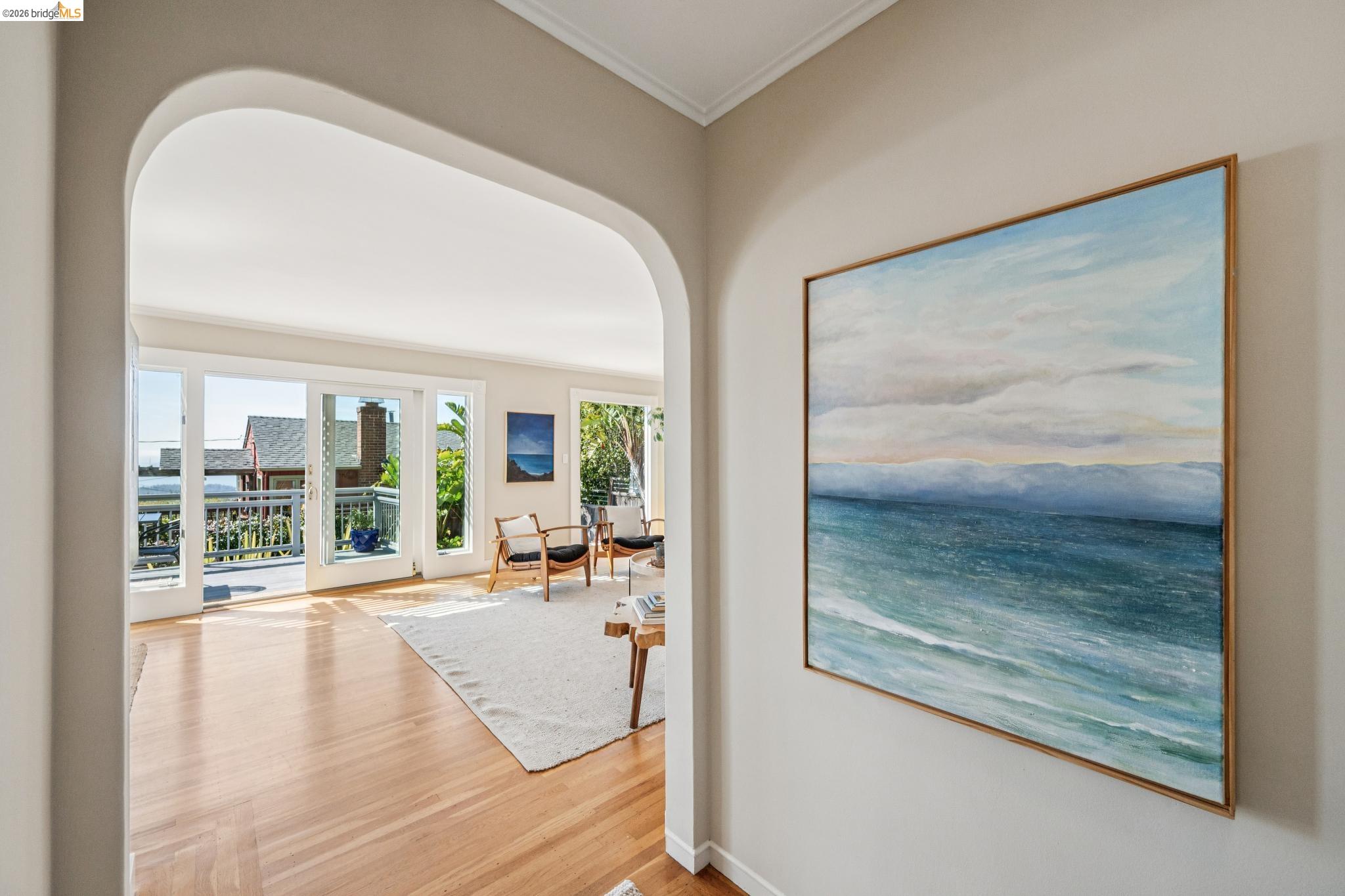 290 Colgate Avenue Kensington, CA 94708 - Photo 7 of 52 Corridor with arched walkways, light wood-type flooring, and crown molding