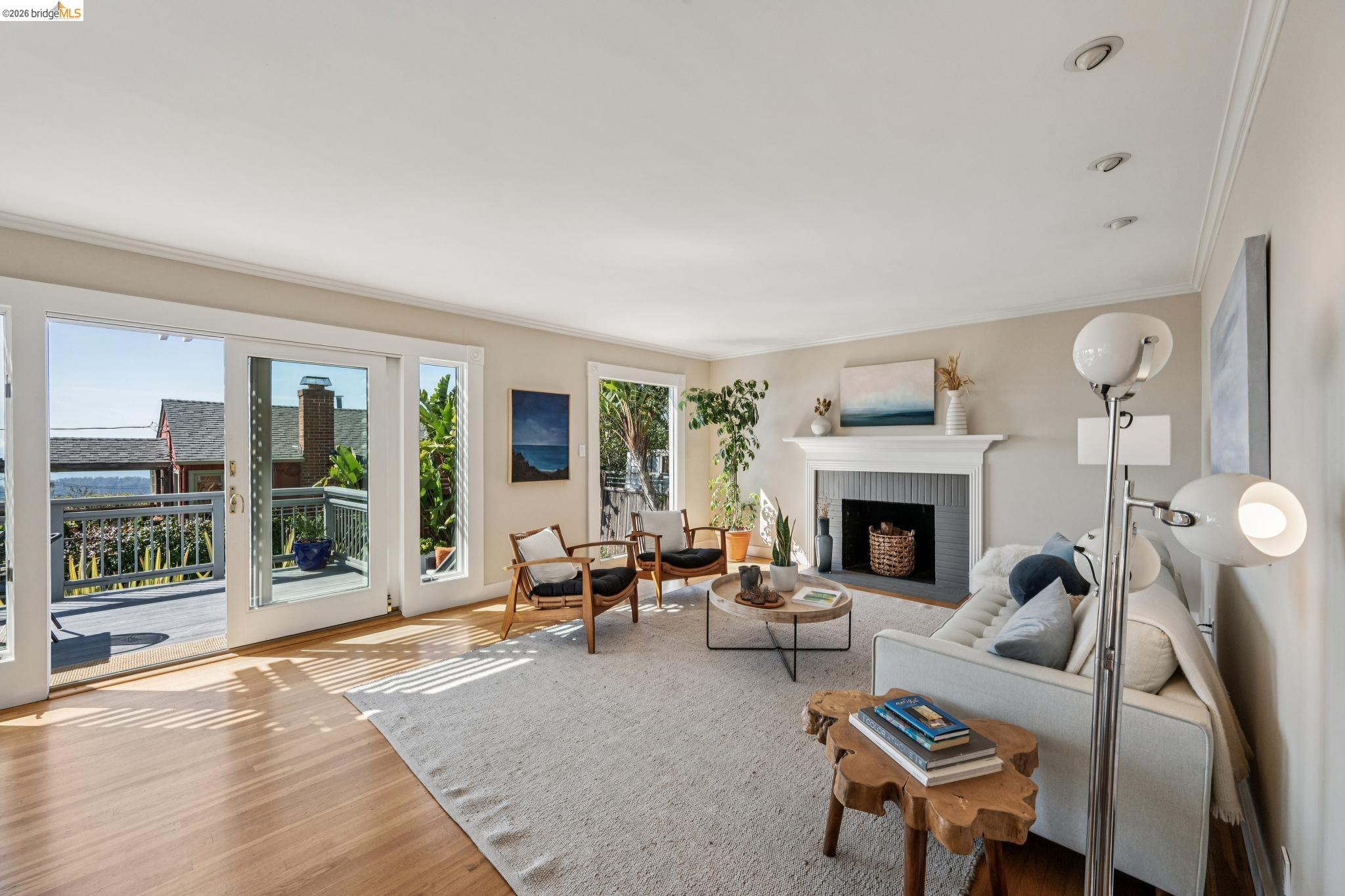 290 Colgate Avenue Kensington, CA 94708 - Photo 9 of 52 Living room with wood finished floors, a brick fireplace, and crown molding