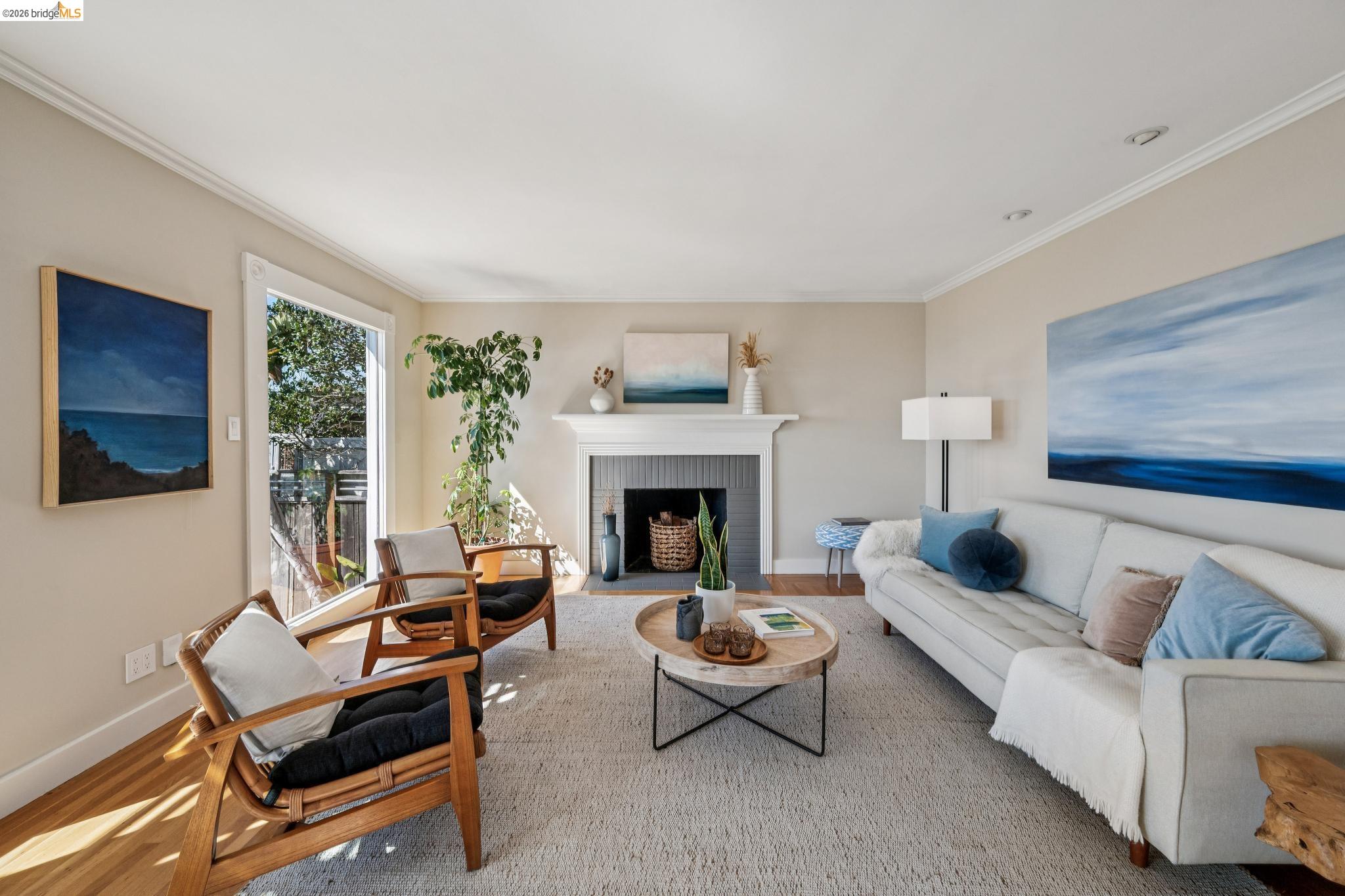 290 Colgate Avenue Kensington, CA 94708 - Photo 10 of 52 Living area featuring a brick fireplace, ornamental molding, and wood finished floors