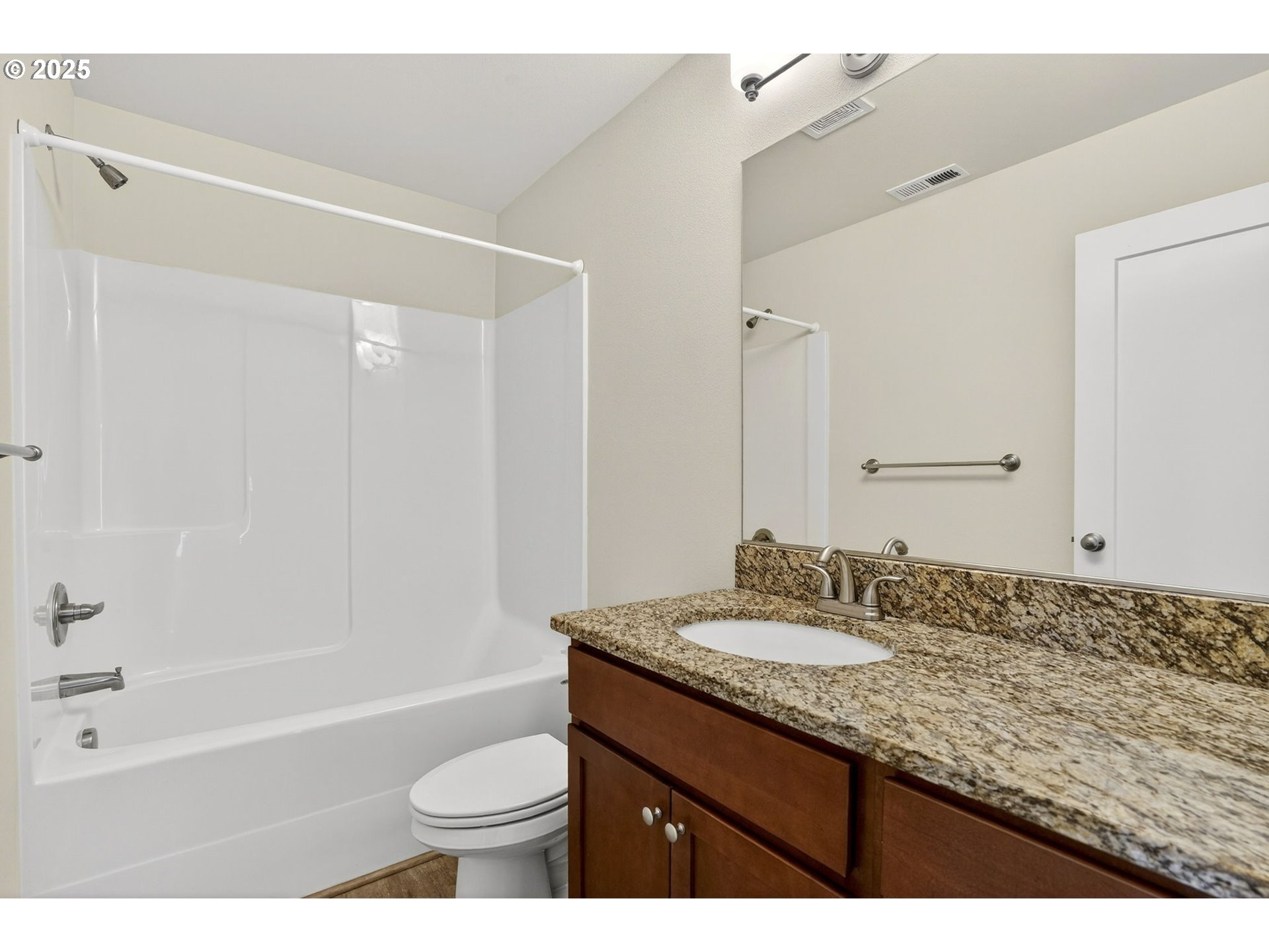 464 Northeast 3rd Avenue Canby, OR 97013 - Photo 22 of 28 a bathroom with a granite countertop sink a toilet a mirror and bathtub