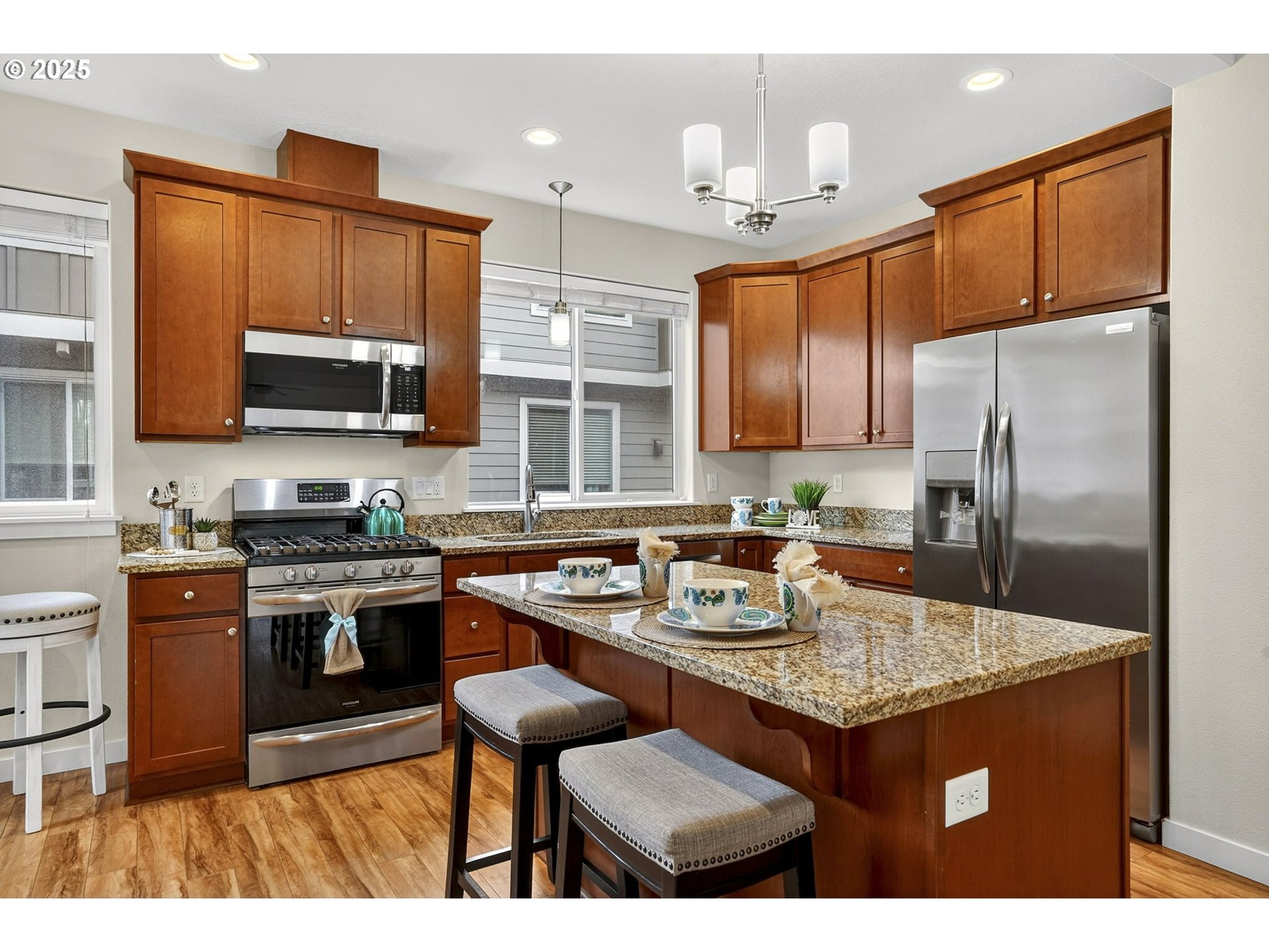 464 Northeast 3rd Avenue Canby, OR 97013 - Photo 8 of 28 a kitchen with stainless steel appliances granite countertop a sink stove and refrigerator