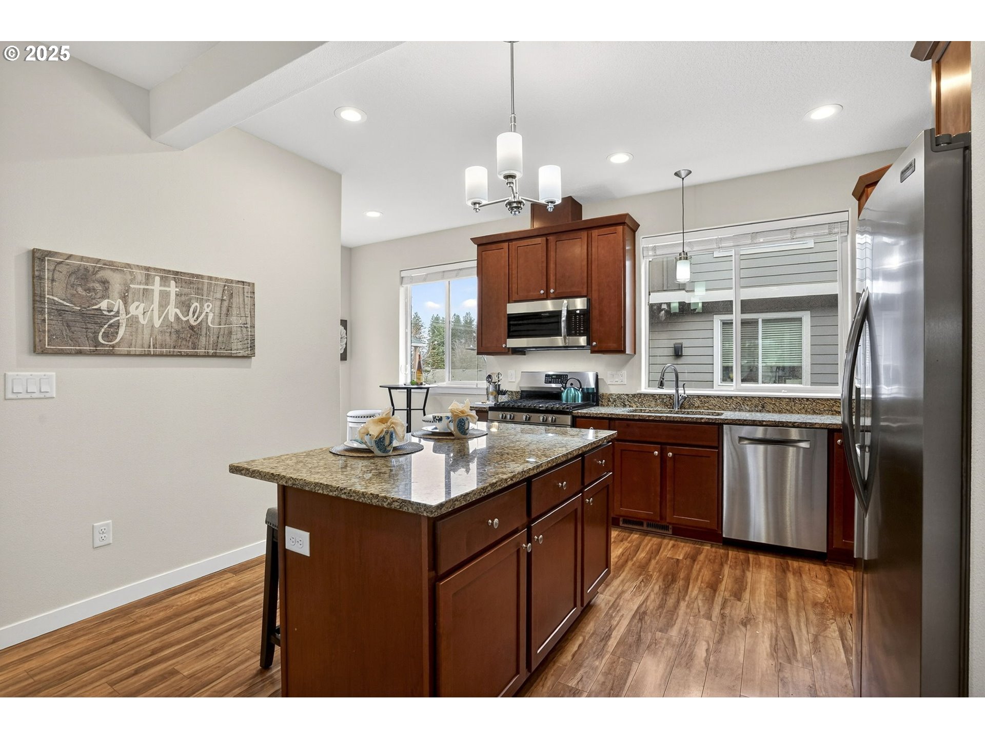 464 Northeast 3rd Avenue Canby, OR 97013 - Photo 9 of 28 a kitchen with kitchen island granite countertop a sink appliances and cabinets