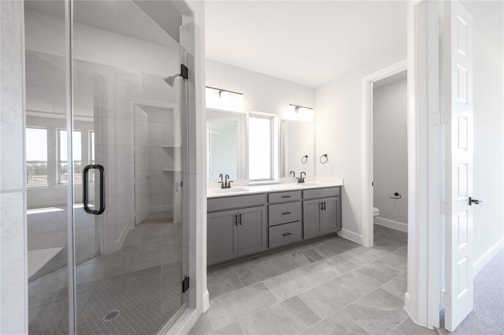 3307 Guardian Angel Court Heath, TX 75126 - Photo 14 of 40 a bathroom with a double vanity sink toilet and shower