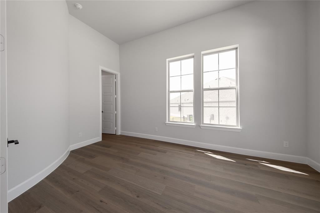 3307 Guardian Angel Court Heath, TX 75126 - Photo 17 of 40 an empty room with wooden floor and windows