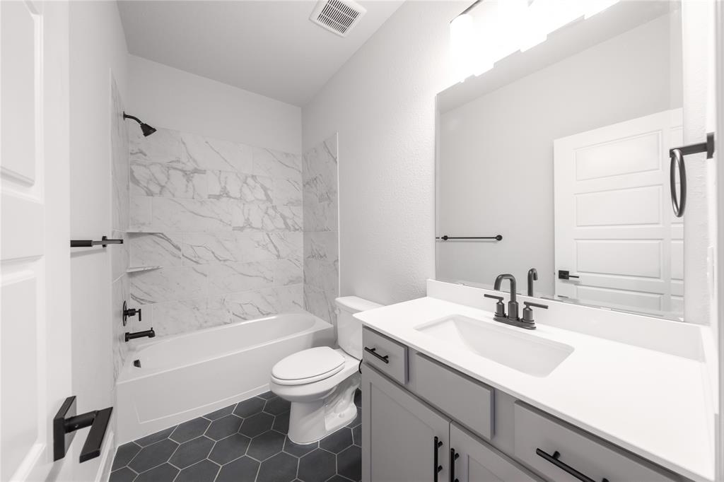3307 Guardian Angel Court Heath, TX 75126 - Photo 25 of 40 a bathroom with a sink a toilet and a bathtub