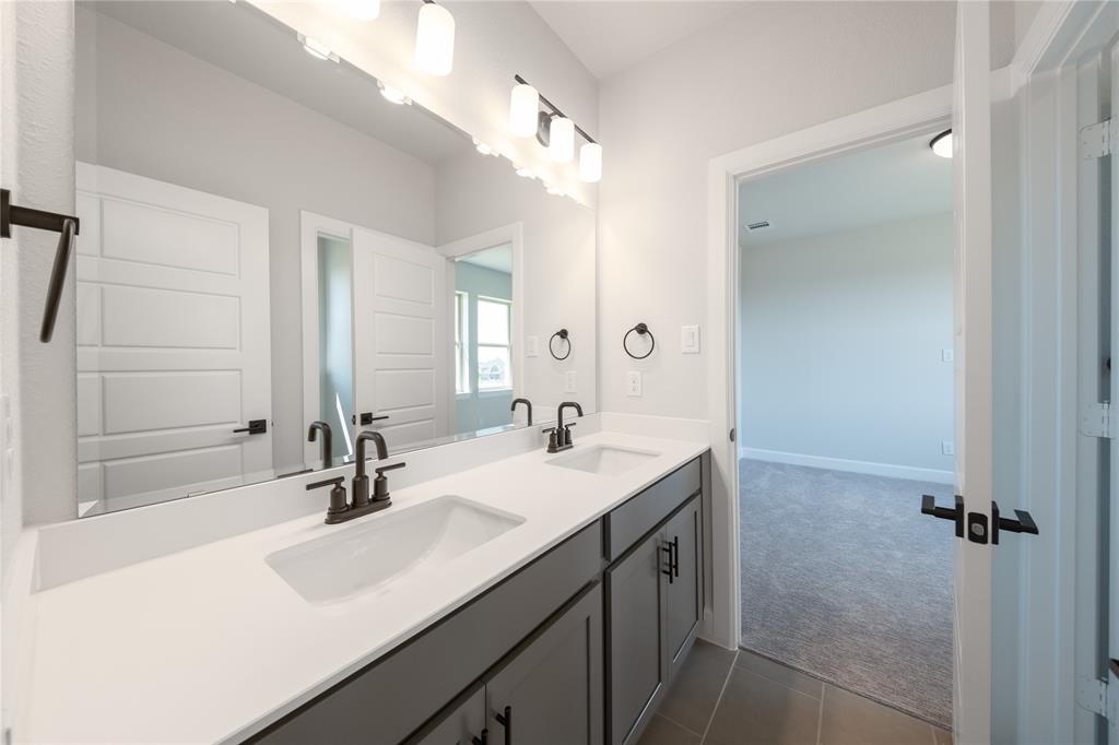 3307 Guardian Angel Court Heath, TX 75126 - Photo 28 of 40 a bathroom with a sink and a mirror