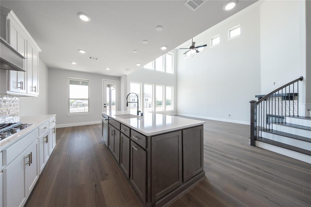 3307 Guardian Angel Court Heath, TX 75126 - Photo 3 of 40 a kitchen with granite countertop a stove and wooden floor
