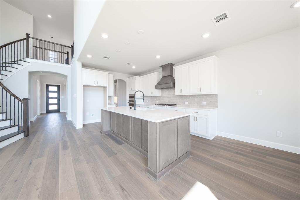 3307 Guardian Angel Court Heath, TX 75126 - Photo 5 of 40 a kitchen with a sink cabinets and wooden floor