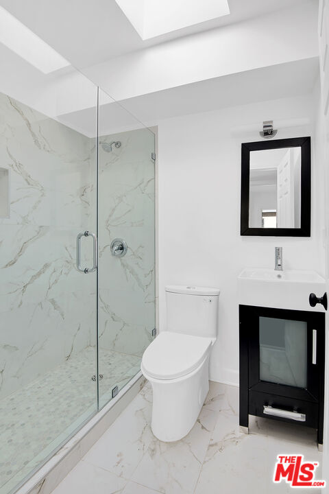 1610 South Beverly Glen Boulevard, Unit 6 Los Angeles, CA 90024 - Photo 12 of 16 a bathroom with a toilet a sink and shower