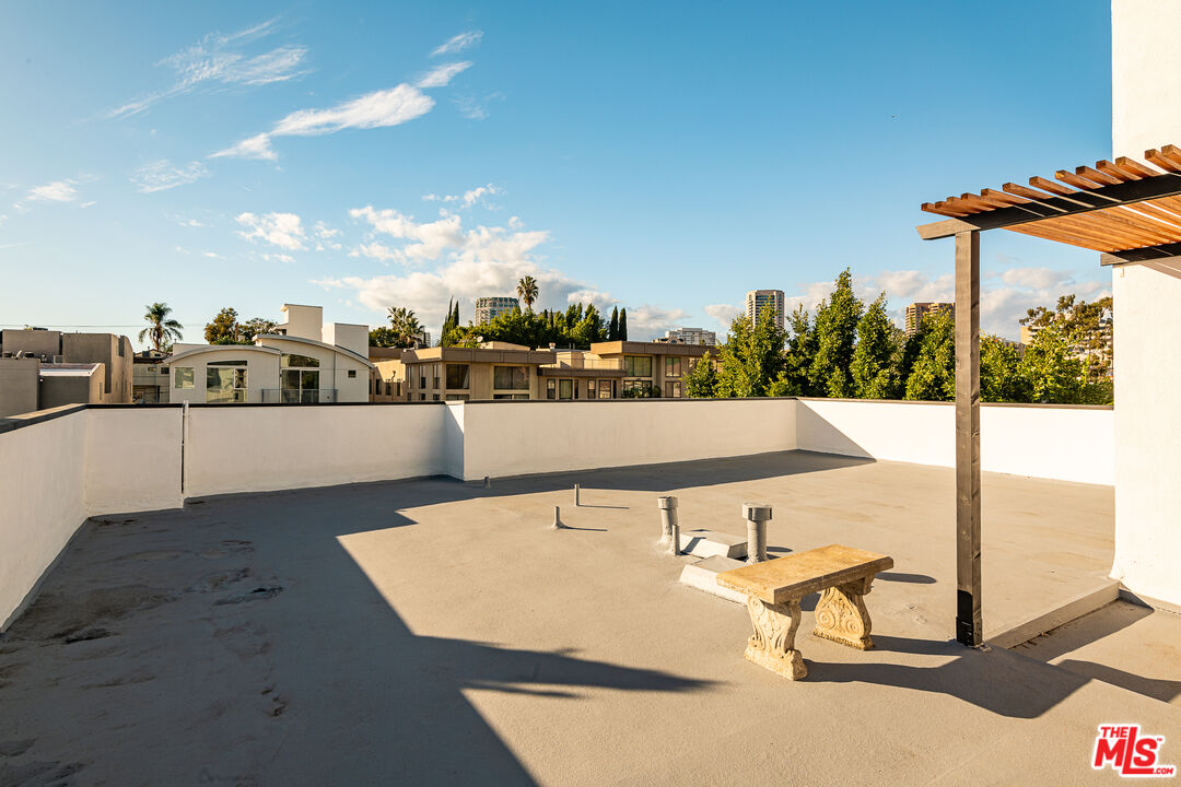 1610 South Beverly Glen Boulevard, Unit 6 Los Angeles, CA 90024 - Photo 16 of 16 a view of a swimming pool with outdoor seating and plants