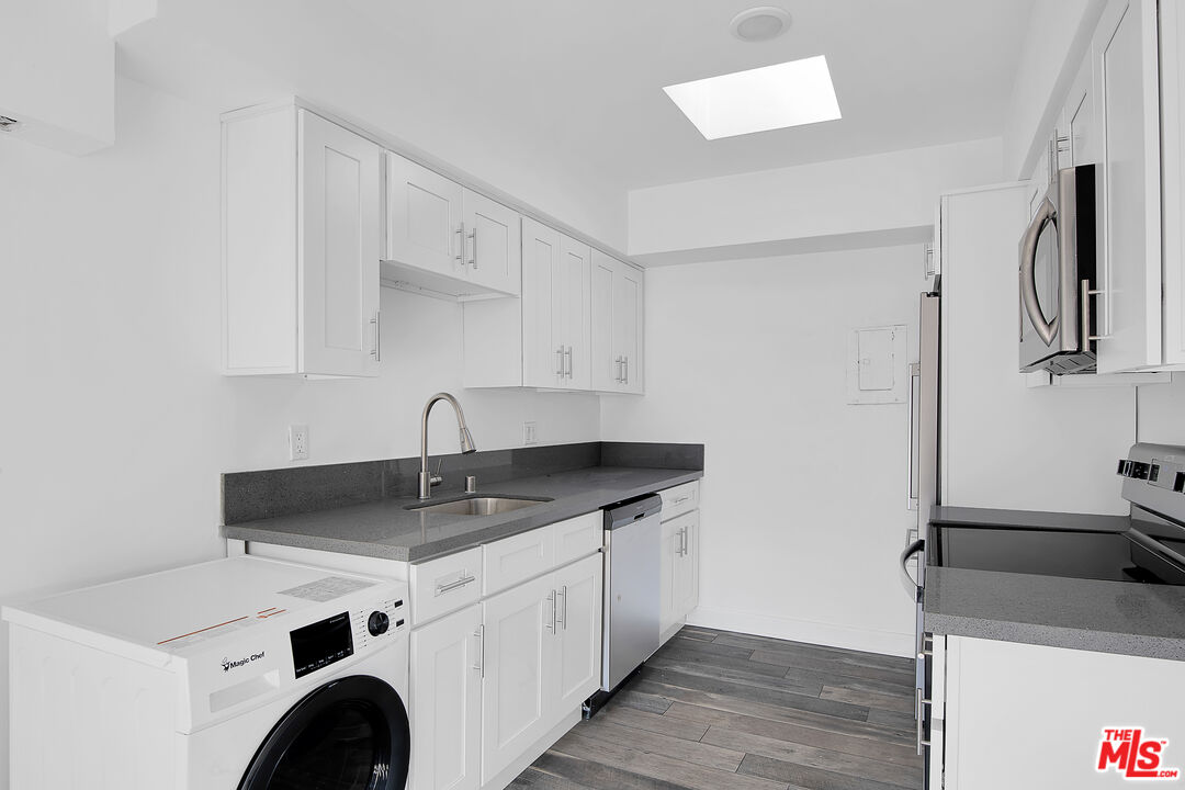 1610 South Beverly Glen Boulevard, Unit 6 Los Angeles, CA 90024 - Photo 3 of 16 a view of cabinets a sink and dishwasher in a kitchen