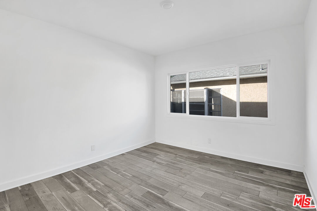 1610 South Beverly Glen Boulevard, Unit 6 Los Angeles, CA 90024 - Photo 8 of 16 a view of an empty room with wooden floor and a window