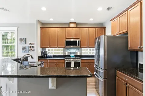 a kitchen with a refrigerator and a sink