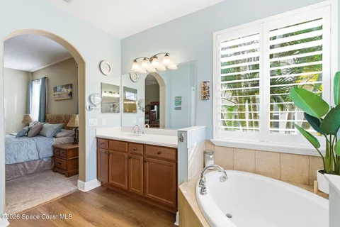 a bathroom with a bathtub a sink and a window