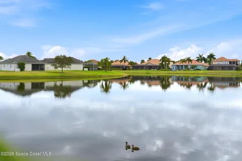 a view of a lake with houses in the background