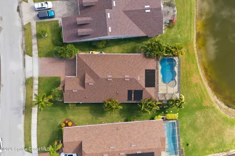 an aerial view of a house with a garden and a yard
