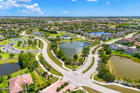 an aerial view of residential houses with outdoor space and swimming pool