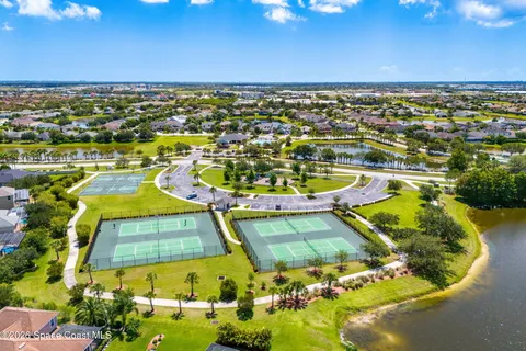 an aerial view of a residential houses with outdoor space and swimming pool