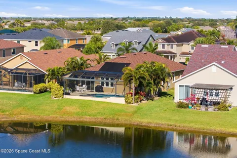 an aerial view of residential houses with outdoor space swimming pool and lake view