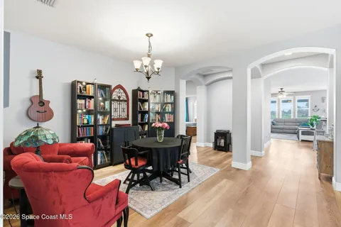 a living room with furniture kitchen and a chandelier
