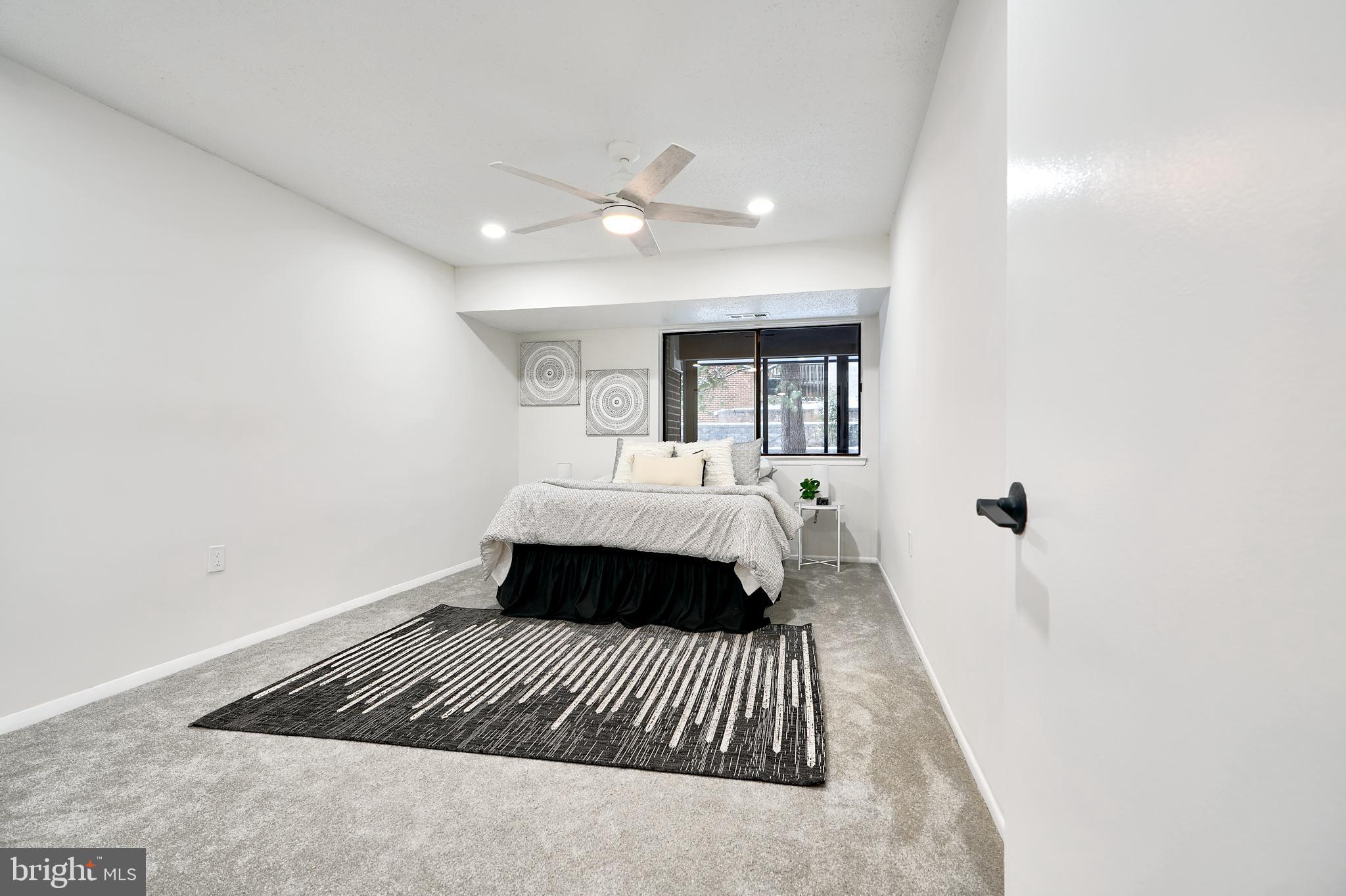 6 Longstream Court, Unit T1 Baltimore, MD 21209 - Photo 12 of 25 a bedroom with a large bed and a chandelier