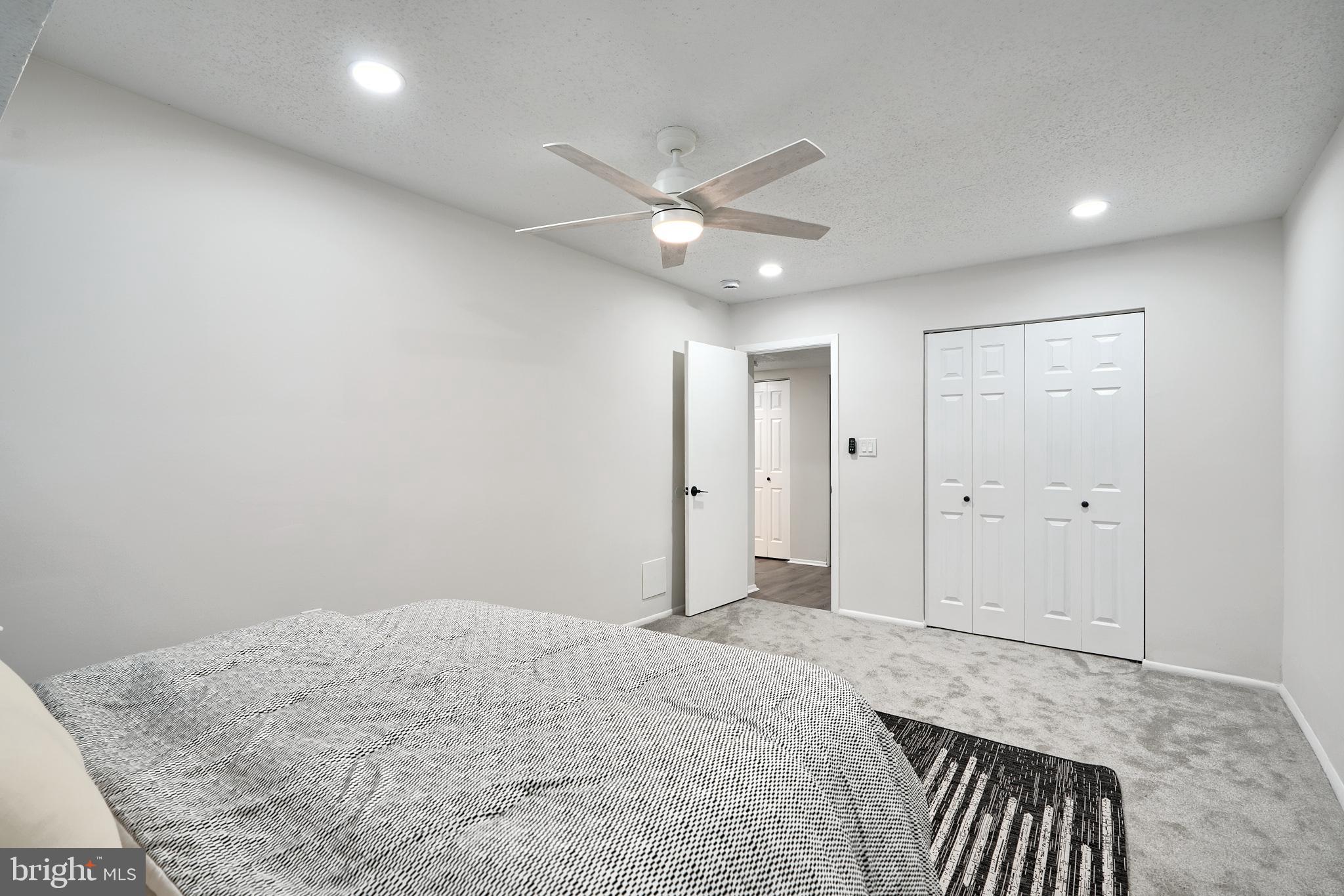 6 Longstream Court, Unit T1 Baltimore, MD 21209 - Photo 14 of 25 a bedroom with a large bed and closet