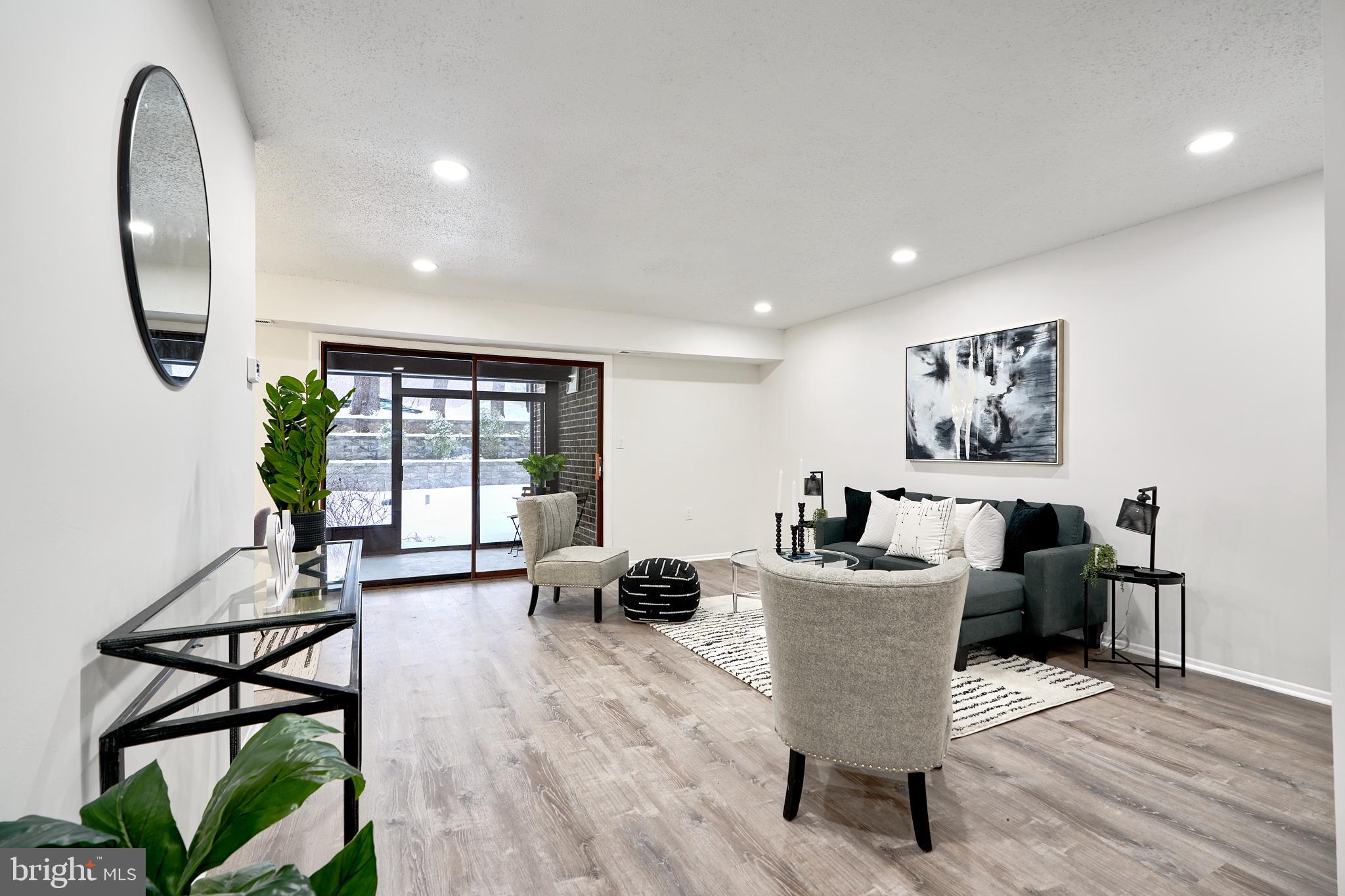6 Longstream Court, Unit T1 Baltimore, MD 21209 - Photo 2 of 25 a living room with furniture a window and wooden floor