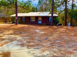 1416 Hibiscus Road Fayetteville, NC 28311 - Photo 1 of 16 a front view of a building with large trees