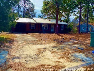 1416 Hibiscus Road Fayetteville, NC 28311 - Photo 2 of 16 a house with trees in front of it