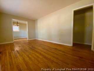 1416 Hibiscus Road Fayetteville, NC 28311 - Photo 8 of 16 an empty room with wooden floor and closet