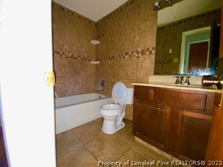 1416 Hibiscus Road Fayetteville, NC 28311 - Photo 9 of 16 a bathroom with a sink a toilet and shower