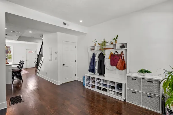 a view of a room with furniture and wooden floor