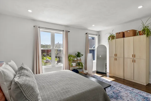a bedroom with a large bed and a window