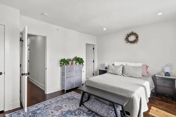 a bedroom with a bed and a potted plant