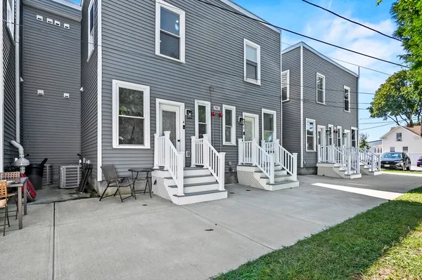 a view of a brick house with many windows