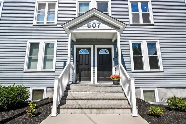 a view of a brick house with large windows
