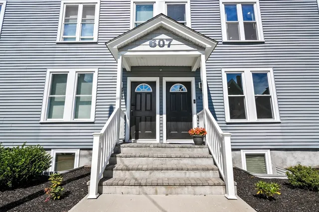 a view of a brick house with large windows