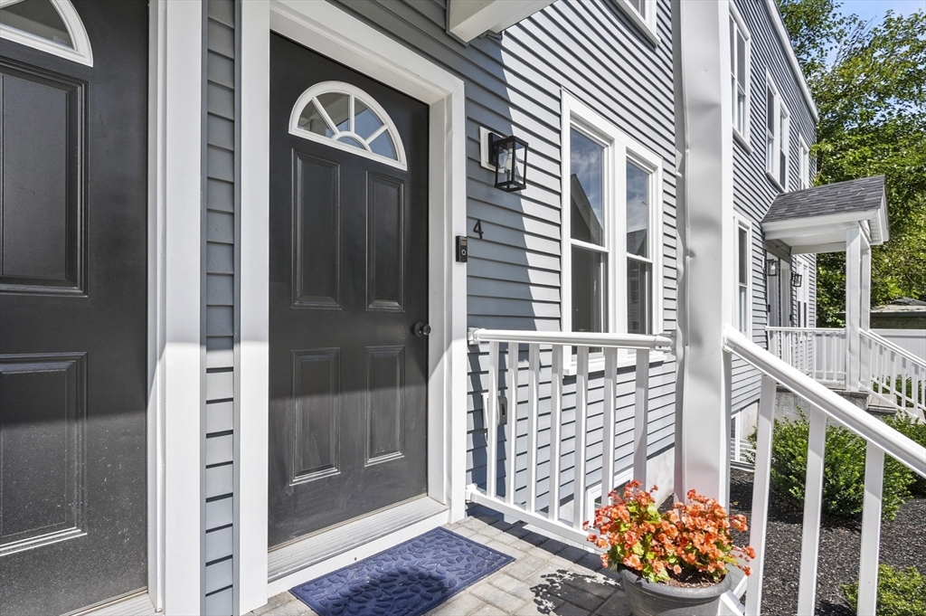 607 Cambridge Street, Unit 4 Worcester, MA 01610 - Photo 4 of 29 a front view of a house with a glass door