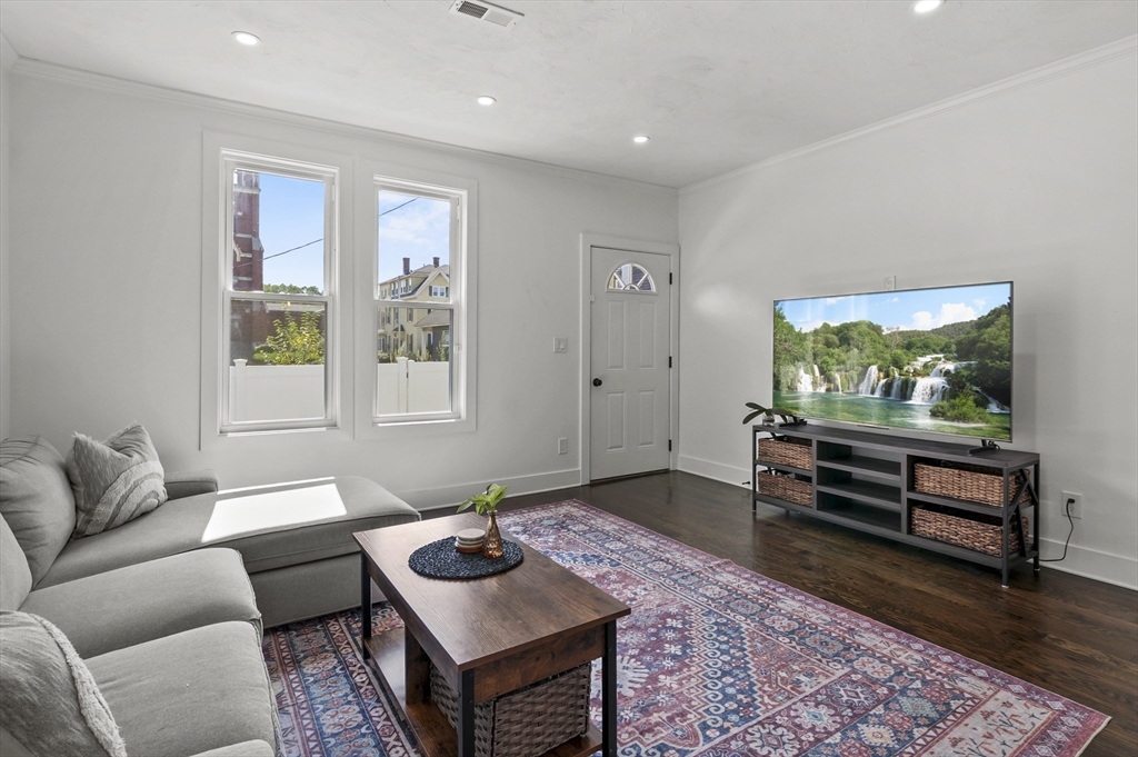 607 Cambridge Street, Unit 4 Worcester, MA 01610 - Photo 6 of 29 a living room with furniture and a flat screen tv