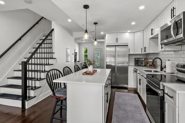 a kitchen with sink cabinets and stainless steel appliances