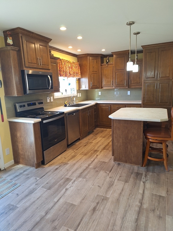 30 Topaz Terrace Gardner, MA 01440 - Photo 6 of 20 a large kitchen with stainless steel appliances wooden floors and wooden cabinets