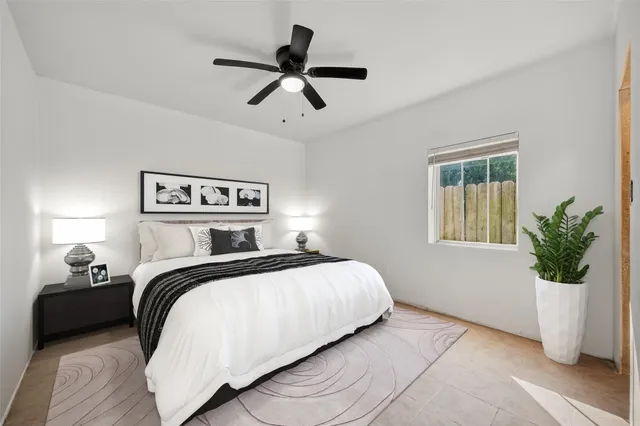 a bedroom with a bed and window