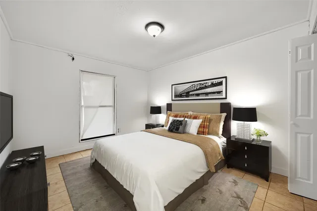 a bedroom with a bed and a night stand