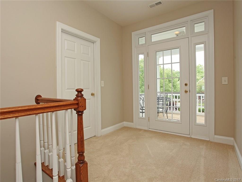 2416 Commons Court Fort Mill, SC 29708 - Photo 22 of 24 a view of a hallway with wooden floor and windows