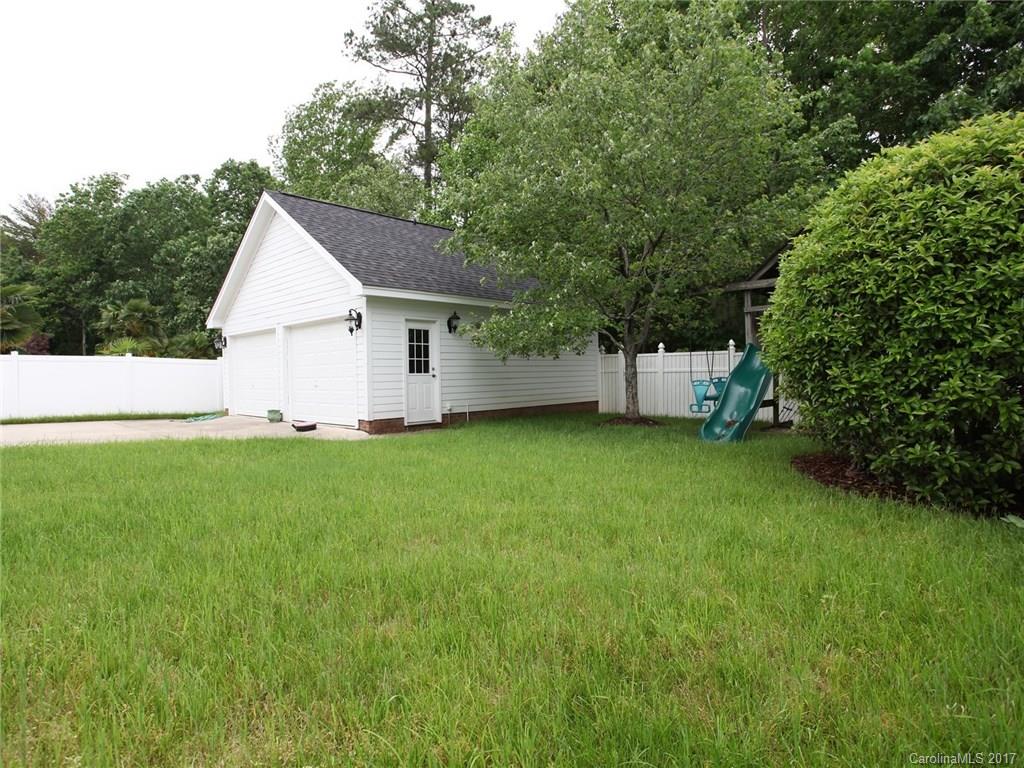 2416 Commons Court Fort Mill, SC 29708 - Photo 24 of 24 a view of a backyard with a garden and entertaining space