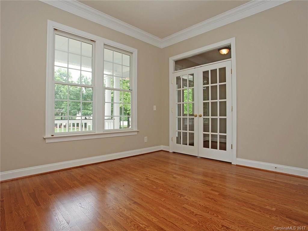 2416 Commons Court Fort Mill, SC 29708 - Photo 10 of 24 a view of an empty room with wooden floor and windows