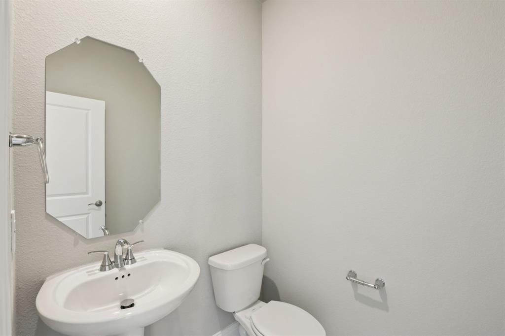 1729 Arches Road Anna, TX 75409 - Photo 11 of 27 a bathroom with a toilet a sink and mirror