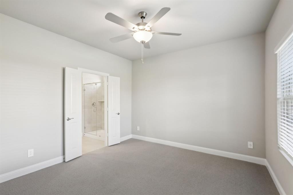 1729 Arches Road Anna, TX 75409 - Photo 12 of 27 an empty room with a window and a ceiling fan