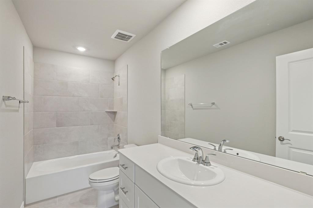 1729 Arches Road Anna, TX 75409 - Photo 21 of 27 a bathroom with a sink toilet and shower