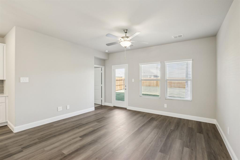1729 Arches Road Anna, TX 75409 - Photo 7 of 27 a view of an empty room with wooden floor and a window